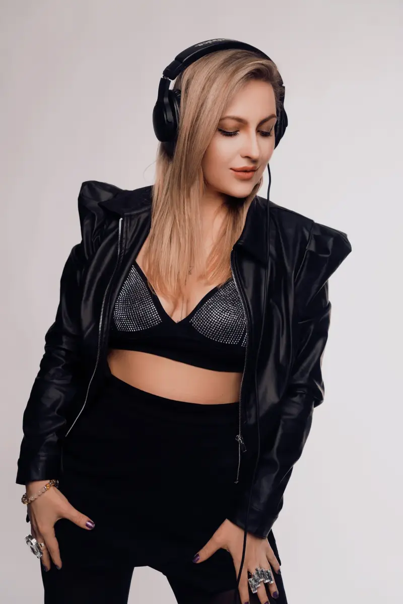 Anna as Lian Gold, wearing headphones